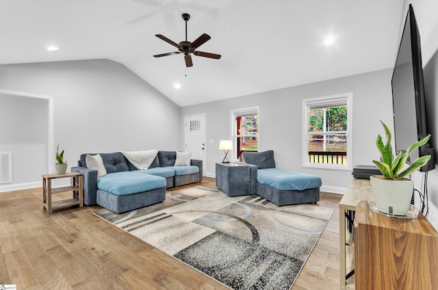 living room featuring ceiling fan, vaulted ceiling, and light wood-type flooring