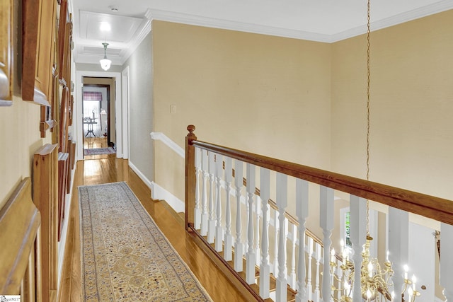 hall with hardwood / wood-style flooring and ornamental molding