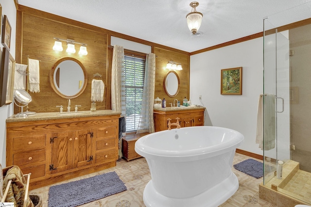 bathroom featuring a textured ceiling, vanity, shower with separate bathtub, and wooden walls