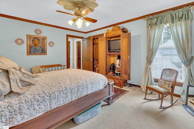 carpeted bedroom with a closet, ceiling fan, and ornamental molding