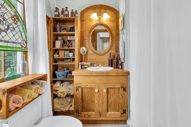 bathroom with vanity and a notable chandelier