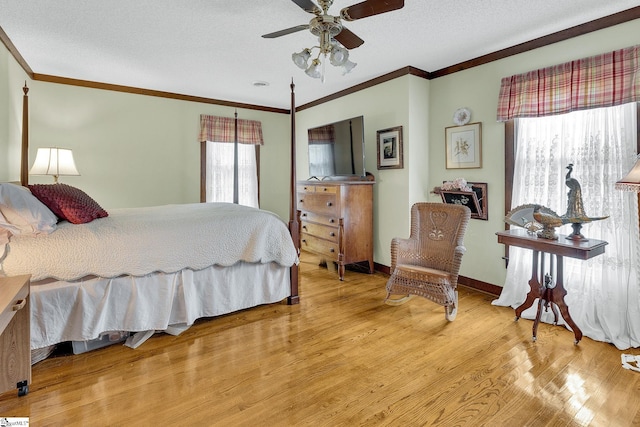 bedroom featuring a textured ceiling, light hardwood / wood-style flooring, ceiling fan, and crown molding