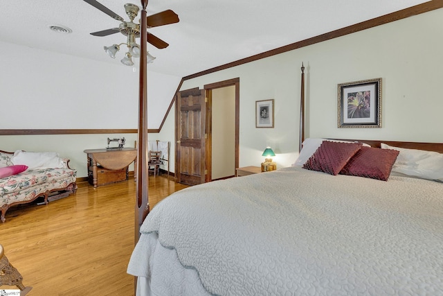 bedroom featuring hardwood / wood-style flooring, ceiling fan, and ornamental molding