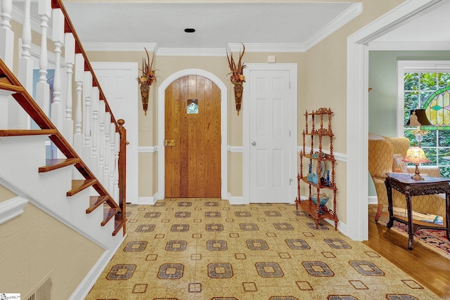 entryway featuring light hardwood / wood-style flooring and crown molding