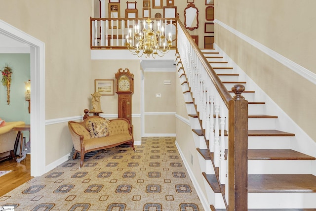 stairs featuring hardwood / wood-style flooring and an inviting chandelier