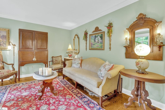 living room with hardwood / wood-style floors and crown molding