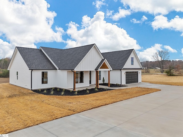 modern inspired farmhouse featuring covered porch and a garage