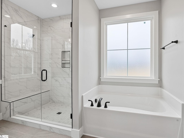 bathroom with tile patterned floors and separate shower and tub