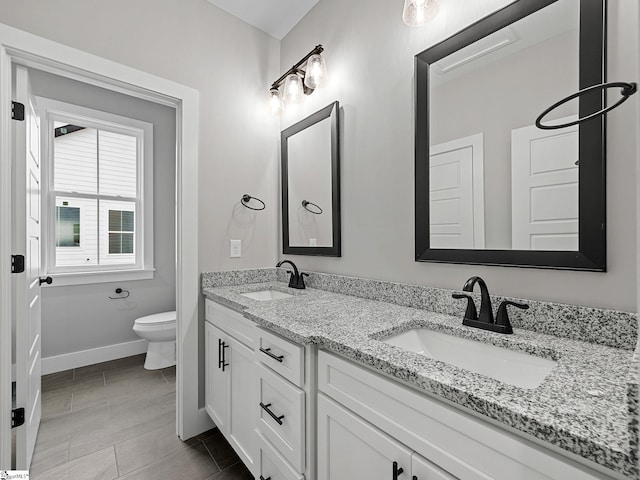 bathroom featuring vanity and toilet