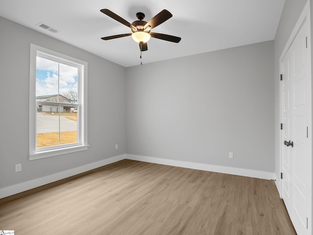 unfurnished bedroom with ceiling fan and light wood-type flooring