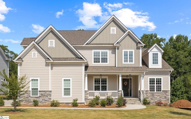 craftsman-style home with covered porch and a front yard