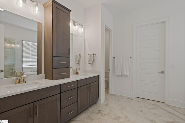 bathroom featuring vanity, an enclosed shower, and toilet