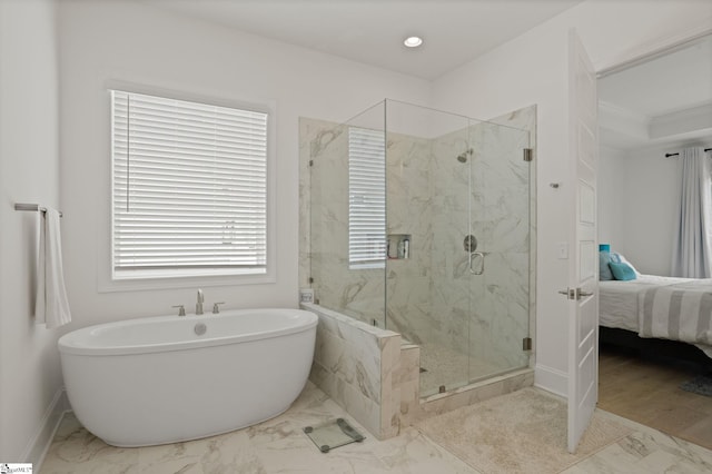 bathroom featuring shower with separate bathtub