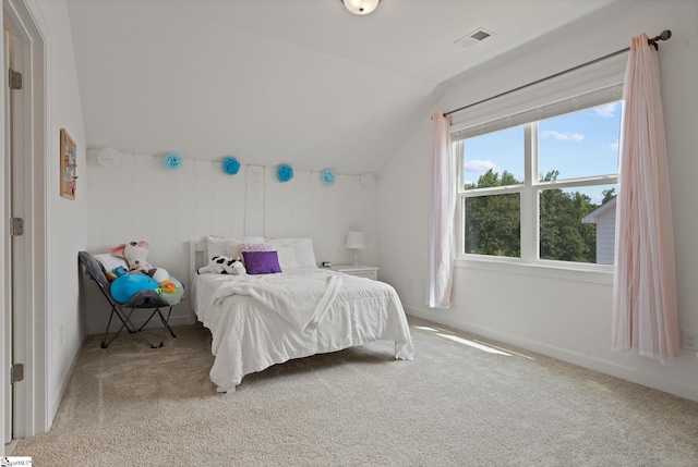 bedroom with light colored carpet and vaulted ceiling