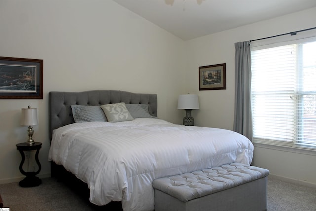 bedroom featuring multiple windows, ceiling fan, carpet floors, and lofted ceiling