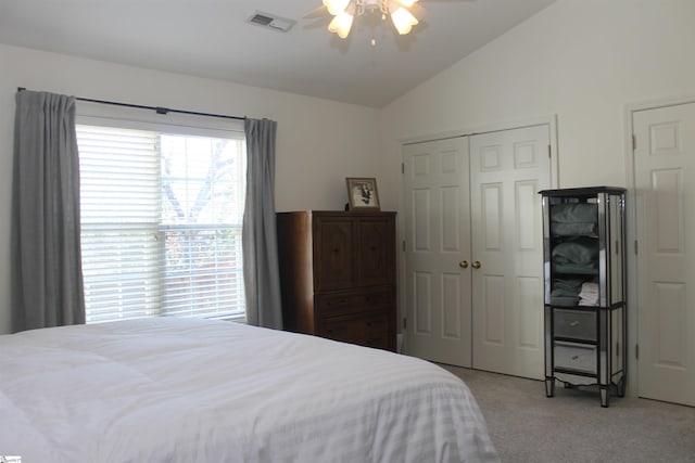 bedroom with ceiling fan, light carpet, and vaulted ceiling