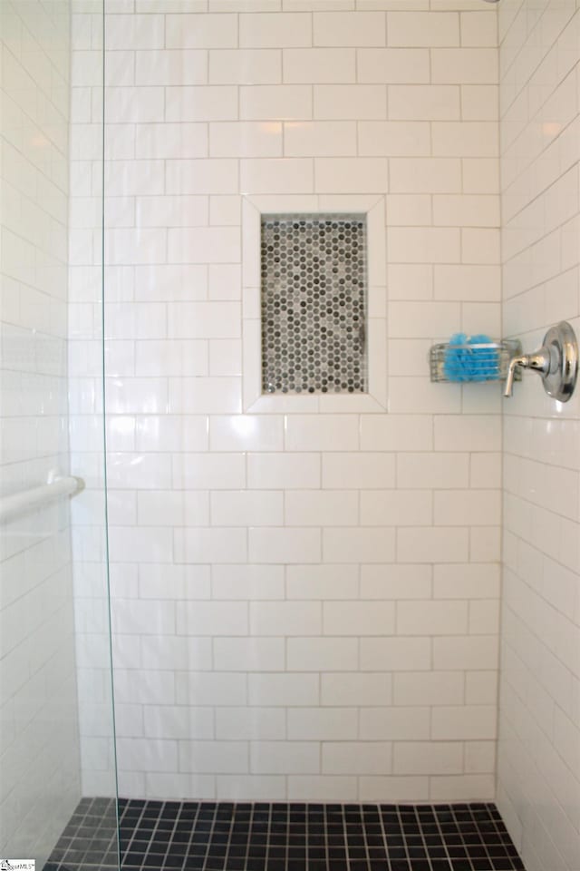 bathroom with tiled shower