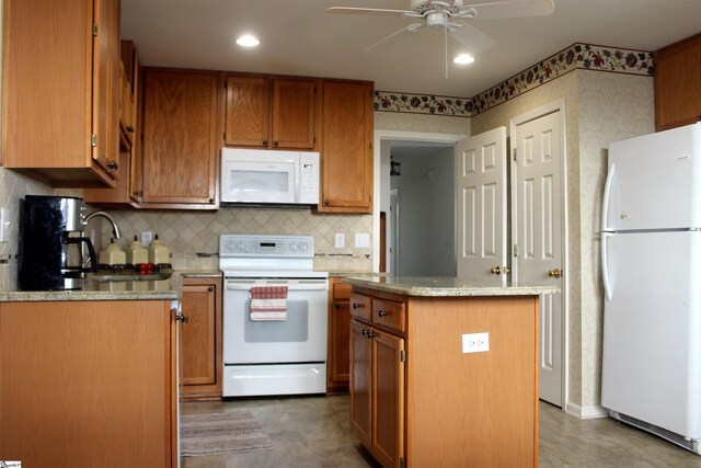 kitchen featuring white appliances, a kitchen island, ceiling fan, and backsplash