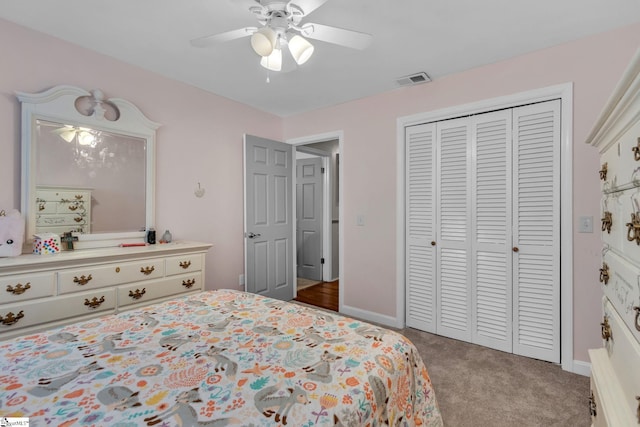 carpeted bedroom featuring a closet and ceiling fan