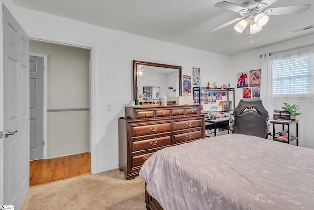 bedroom with ceiling fan and light colored carpet