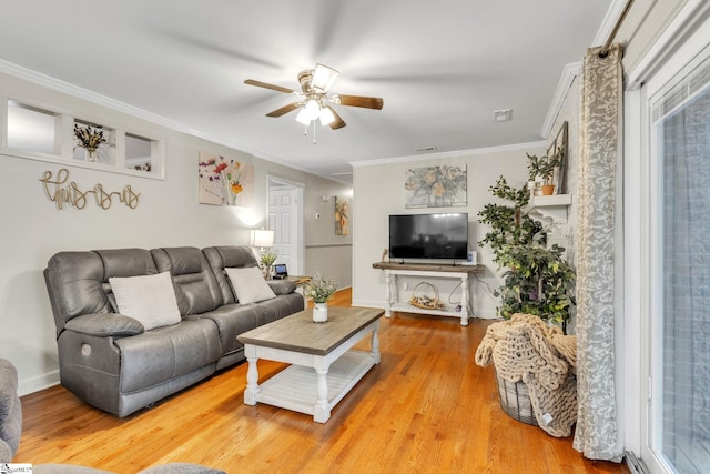 living room featuring hardwood / wood-style floors, ceiling fan, and ornamental molding