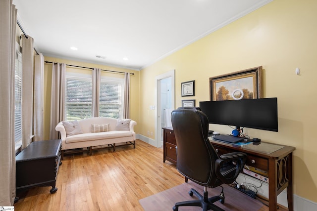 office space featuring crown molding and light hardwood / wood-style flooring