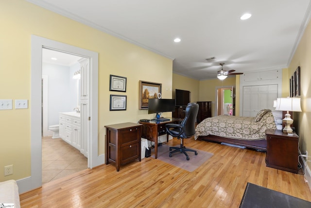 bedroom featuring ensuite bath, light hardwood / wood-style flooring, ceiling fan, ornamental molding, and a closet