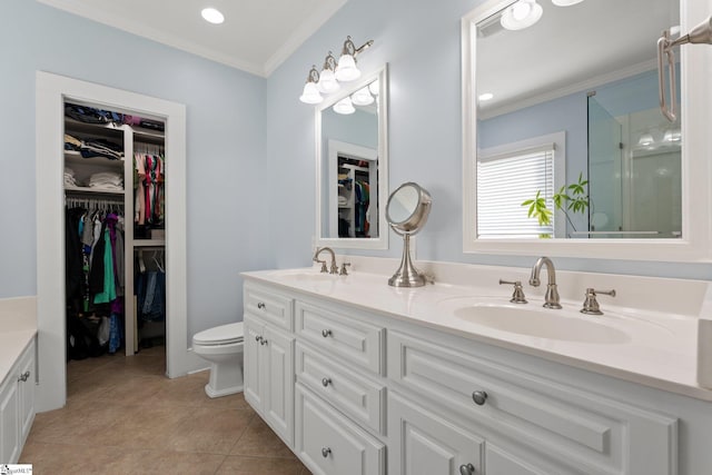 bathroom with tile patterned flooring, vanity, toilet, and crown molding