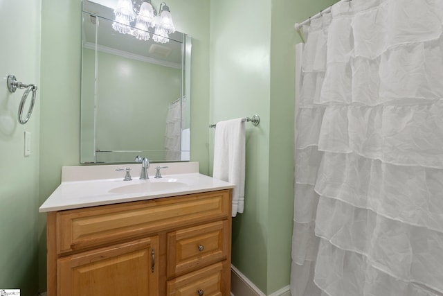 bathroom featuring a shower with curtain, vanity, and ornamental molding