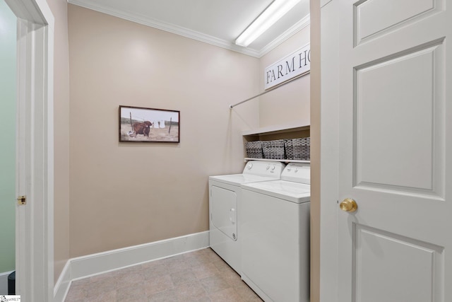 laundry room with ornamental molding and washing machine and clothes dryer