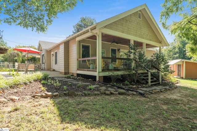 view of side of home featuring a shed, a patio, and a porch