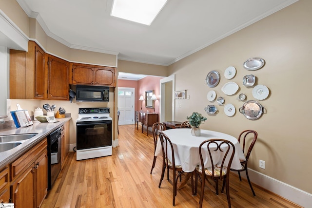 kitchen with crown molding, sink, black appliances, and light wood-type flooring