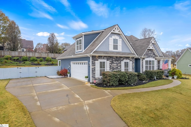 craftsman inspired home with a front yard and a garage