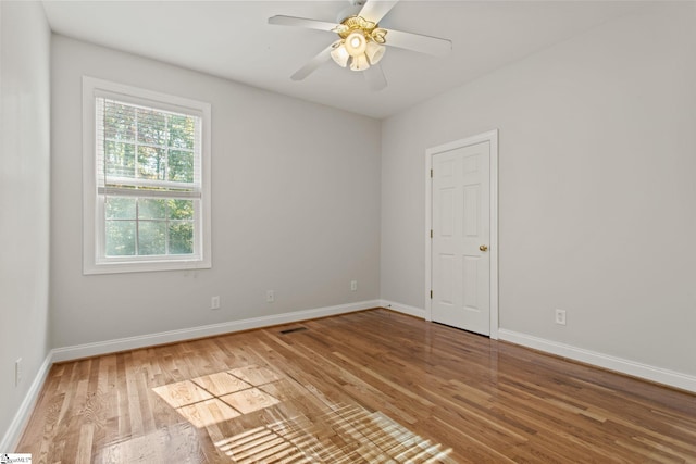 spare room with ceiling fan and wood-type flooring