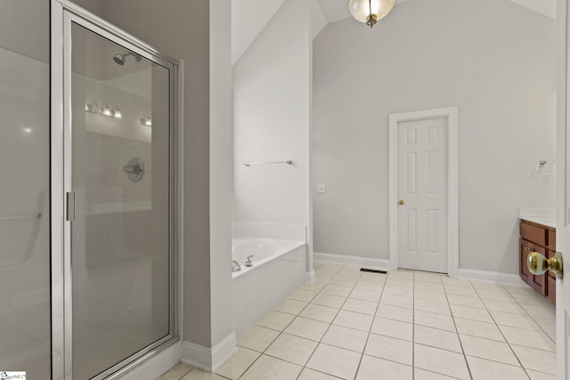 bathroom featuring tile patterned flooring, vanity, independent shower and bath, and lofted ceiling