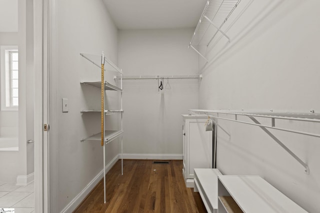 walk in closet featuring dark hardwood / wood-style floors