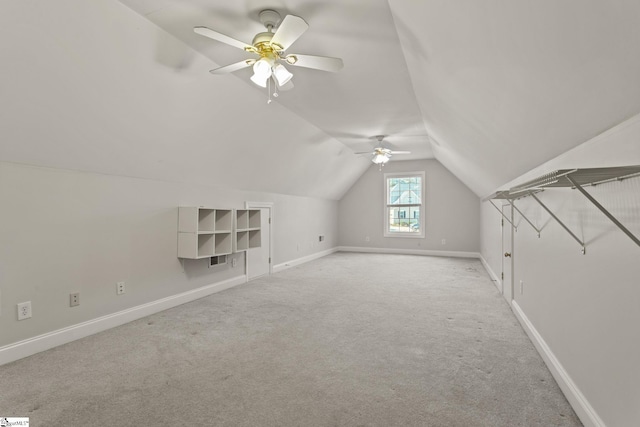 additional living space featuring light carpet, ceiling fan, and lofted ceiling