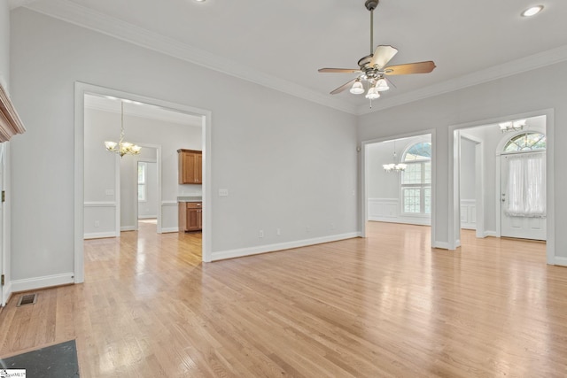 unfurnished living room featuring ceiling fan with notable chandelier, light hardwood / wood-style floors, and crown molding