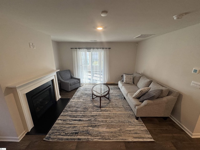 living room featuring dark wood-type flooring