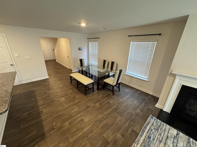 dining space with dark hardwood / wood-style flooring