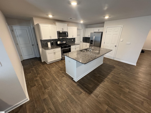 kitchen featuring a center island with sink, dark hardwood / wood-style floors, appliances with stainless steel finishes, tasteful backsplash, and white cabinetry