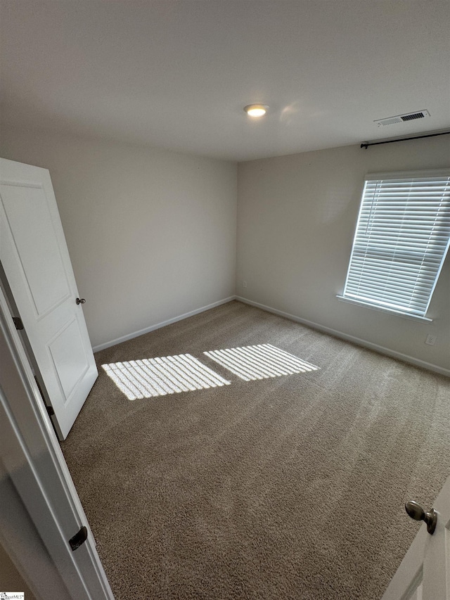 empty room featuring dark colored carpet