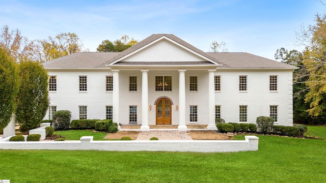 greek revival house with french doors and a front lawn