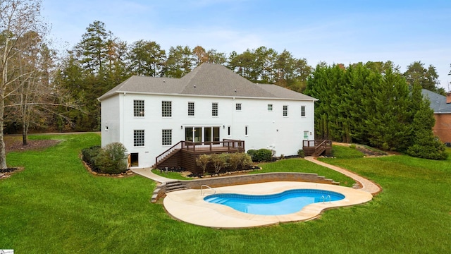 back of property with a yard and a pool side deck