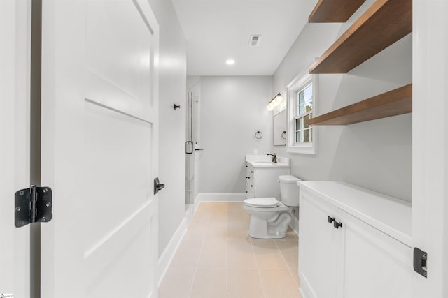 bathroom with tile patterned flooring, vanity, toilet, and a shower with door