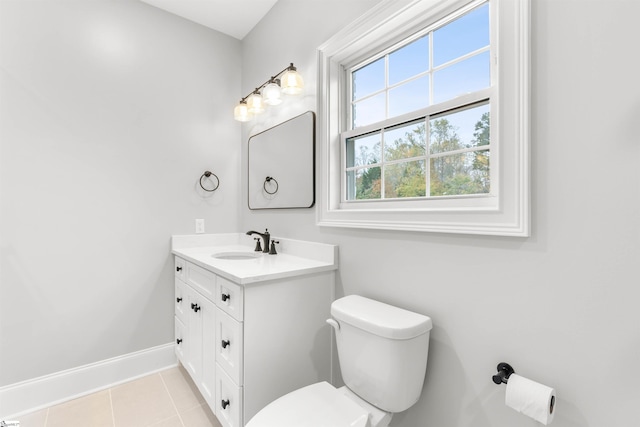 bathroom featuring tile patterned flooring, vanity, and toilet