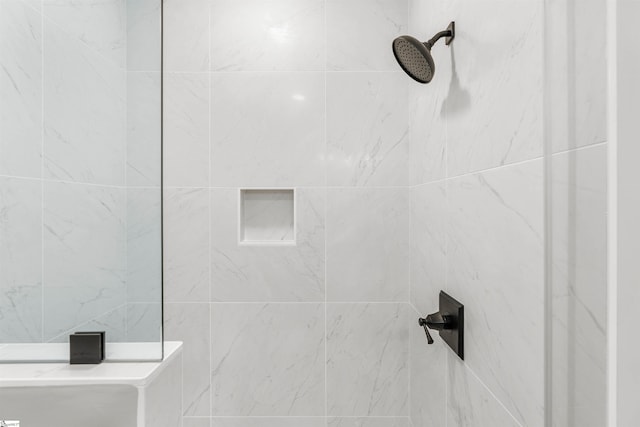 bathroom with tiled shower