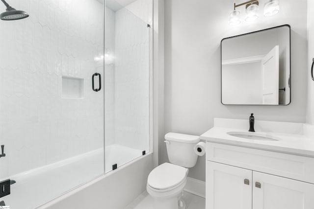 full bathroom with combined bath / shower with glass door, toilet, and vanity