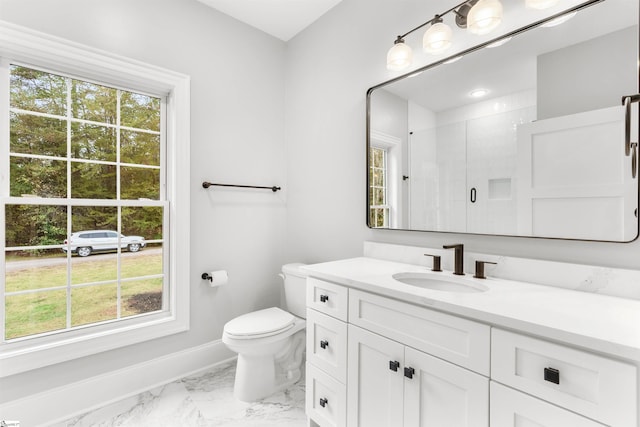 bathroom with vanity, toilet, and walk in shower