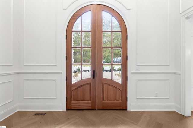 doorway with french doors, light parquet flooring, and plenty of natural light